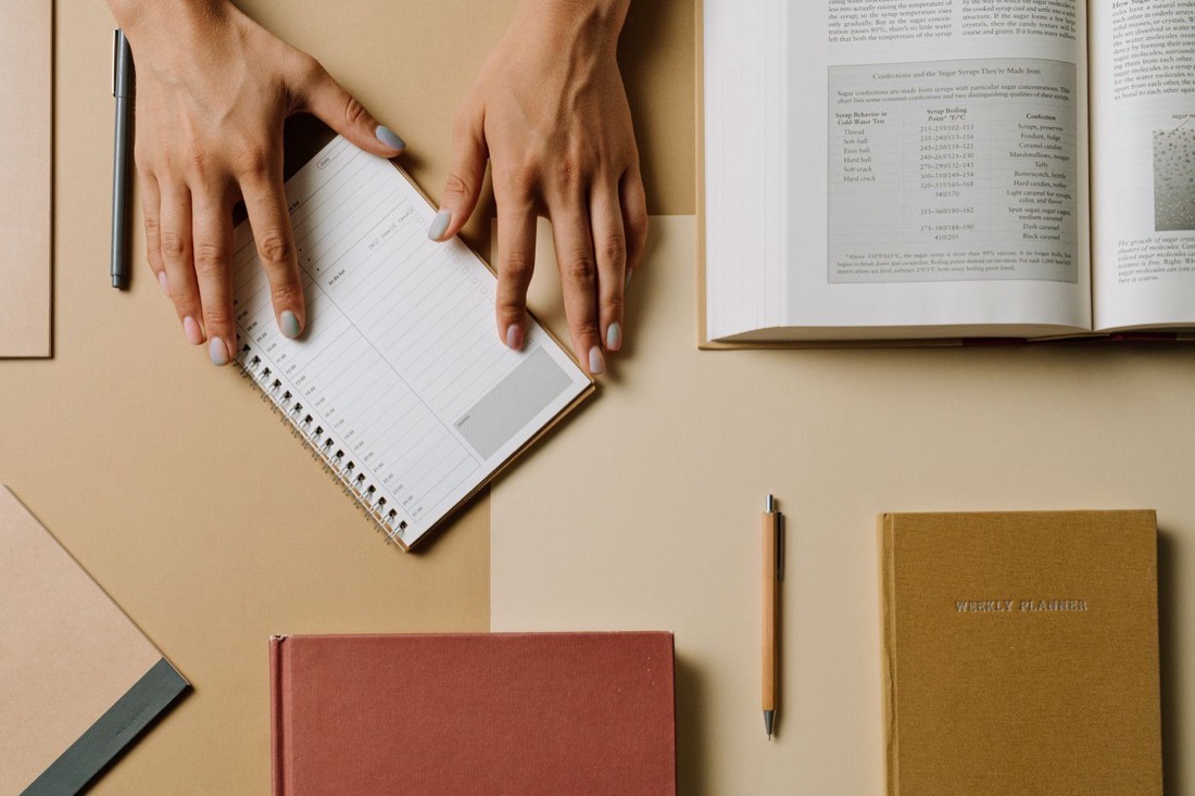 Books and planners on a desk, illustrating when to sit the French test in a PR application