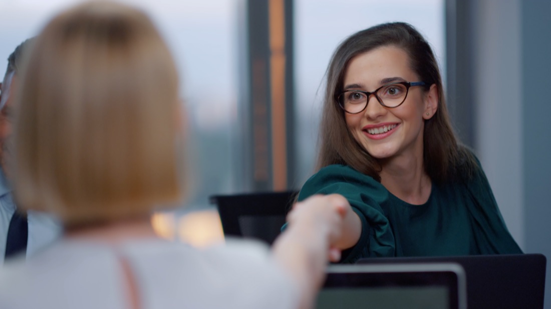 Two people meeting across a desk