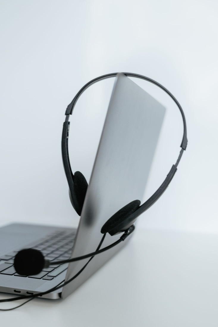 A laptop with a headset resting on it, ready for a recorded practice session